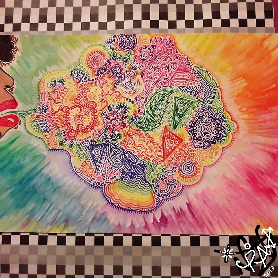 Colorful abstract artwork featuring intricate doodles and patterns emerging from a person's lips. The background has a checkered pattern at the top and multiple colors blending together.