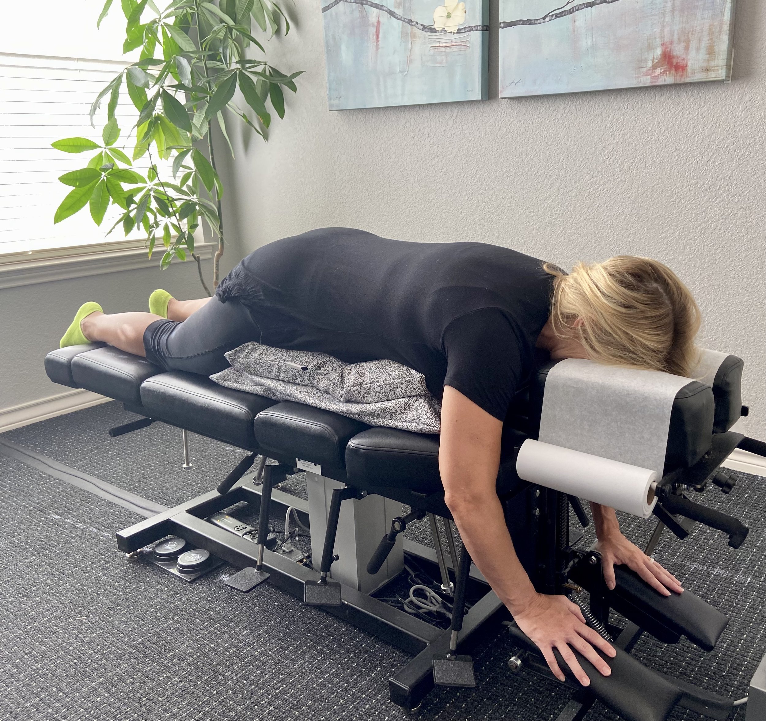 Pregnant patient receiving a gentle upper cervical chiropractic adjustment on a specialized prenatal chiropractic table in Lakeway, TX