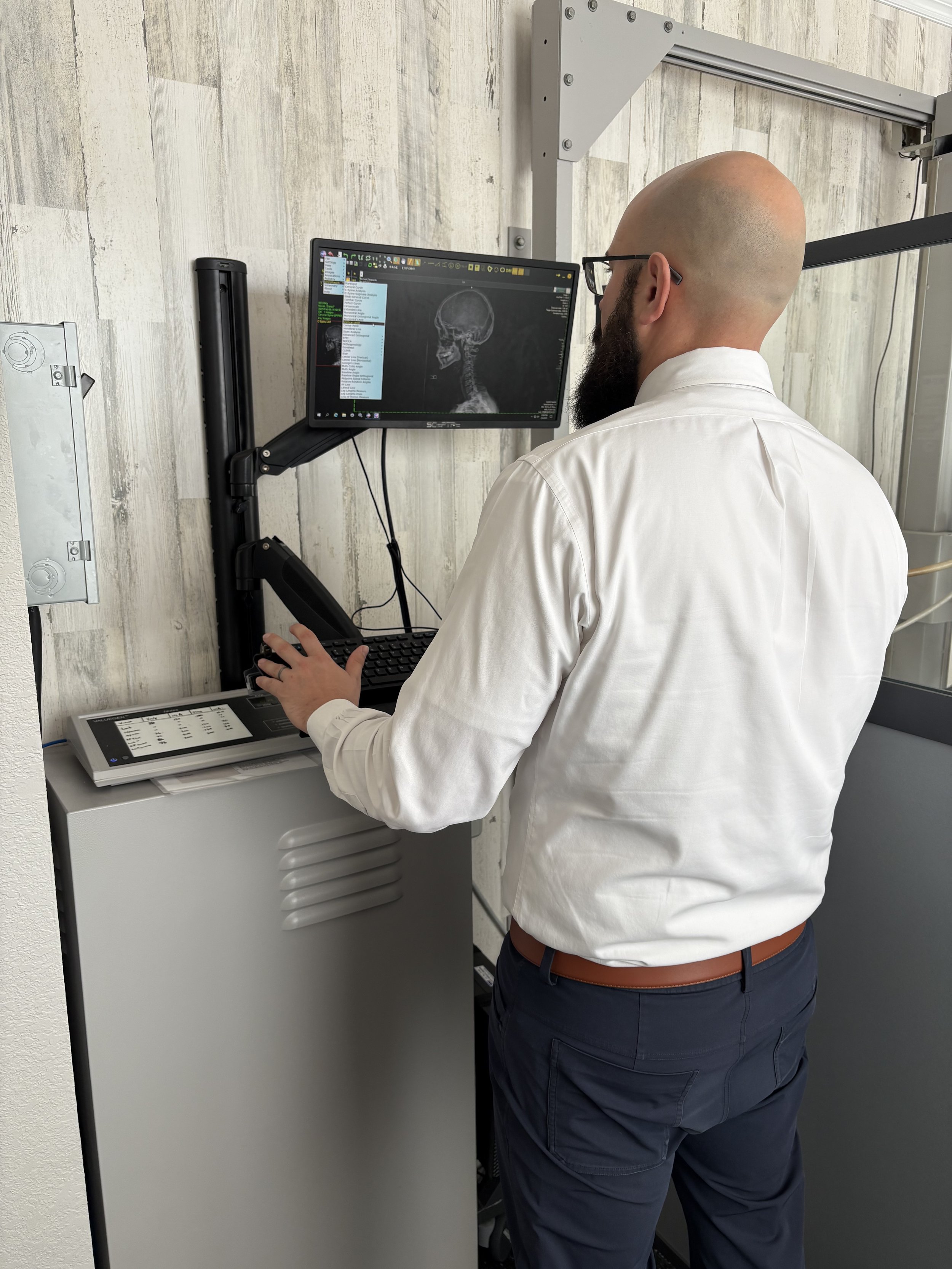 Be Well Chiropractic doctor analyzing precise upper cervical x-ray measurements in Lakeway, TX