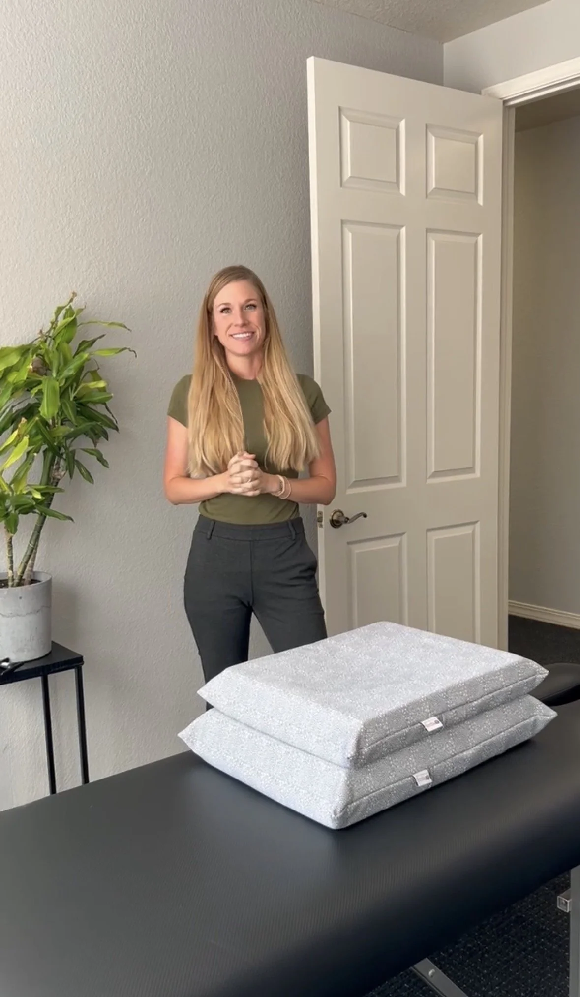 Dr. Alicia Bagwell with prenatal support pillows used for pregnancy-safe chiropractic adjustments in Lakeway, TX