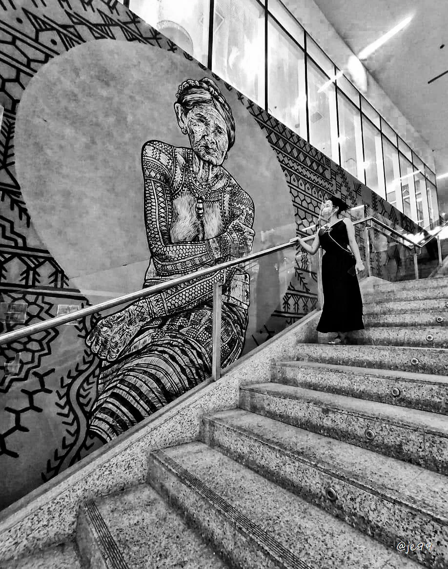 This photo is Whang-od Oggay (Left) a Filipina tattoo artist from Buscalan, Tinglayan, Kalinga, Philippines, the last Mambabatok (tattoo artist) . Aira Tordilla (Right) my childhood friend.  This place was in SM Aura, BGC Taguig city. This place is k