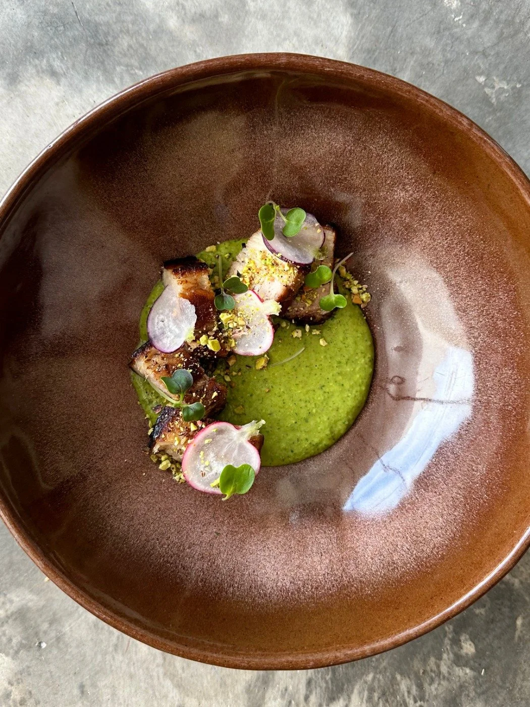 28 hours sous vide pork Belly, seared and served with mole verde, pistachios, and fresh radishes