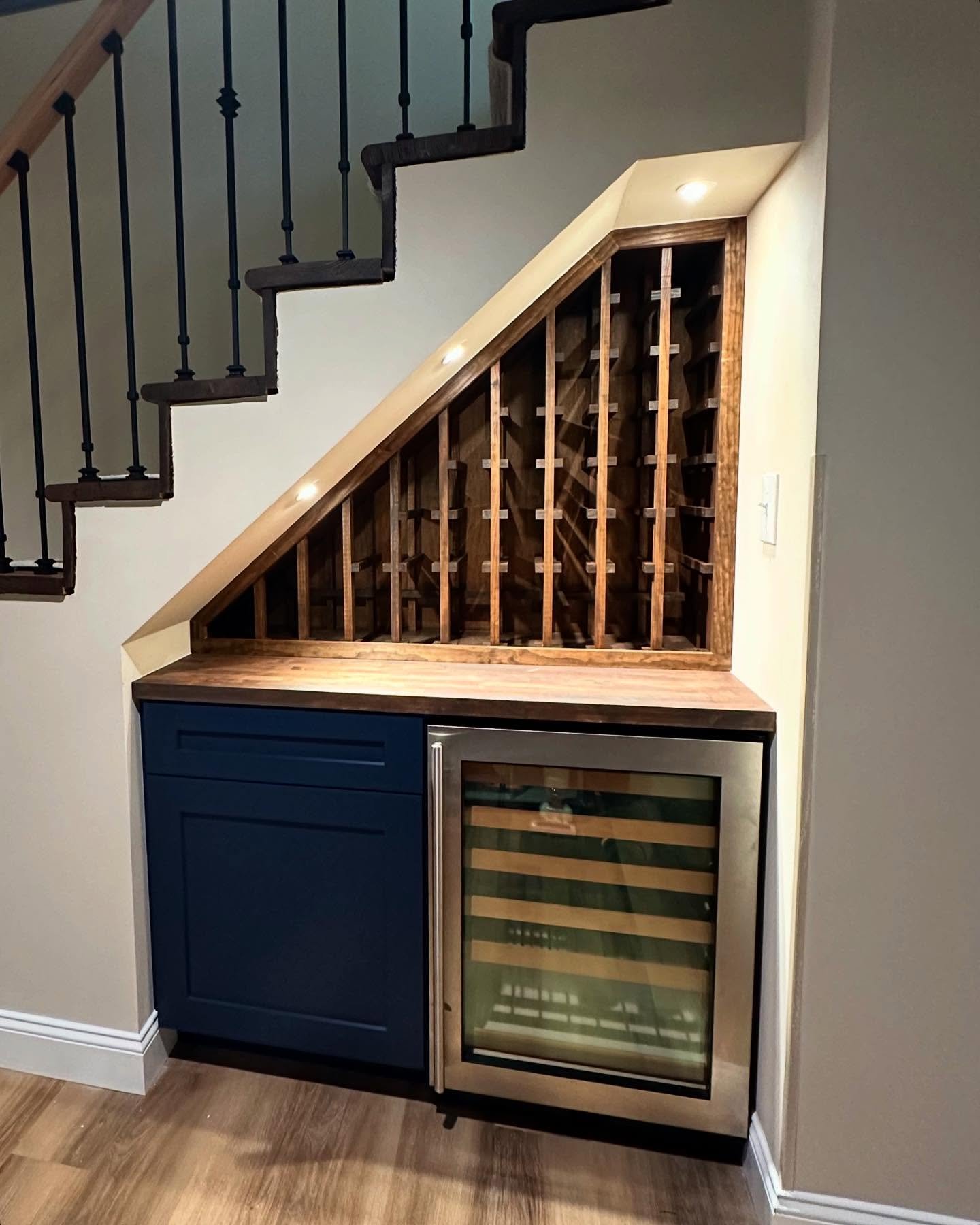 Under-stair dry bar featuring custom wine bottle storage ✅ the angles and seams 👌 I&rsquo;m very happy with how this one turned out!! #basementremodel #winestorage #home #interior #interiordecor #interiordesign