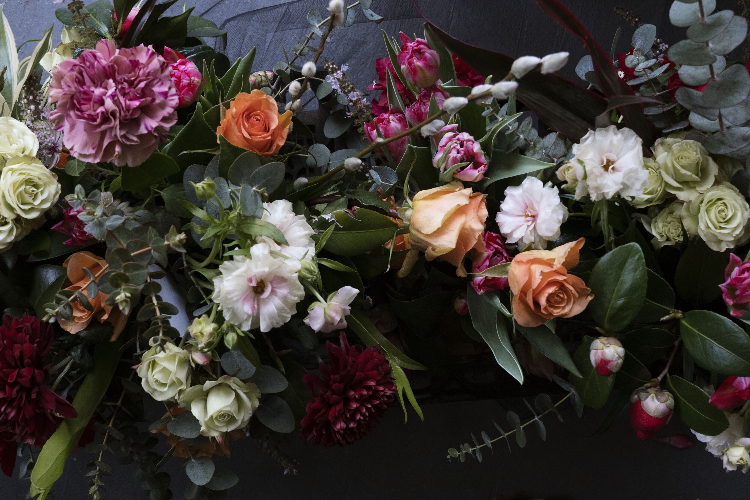 Colorful floral arrangement with various flowers including roses