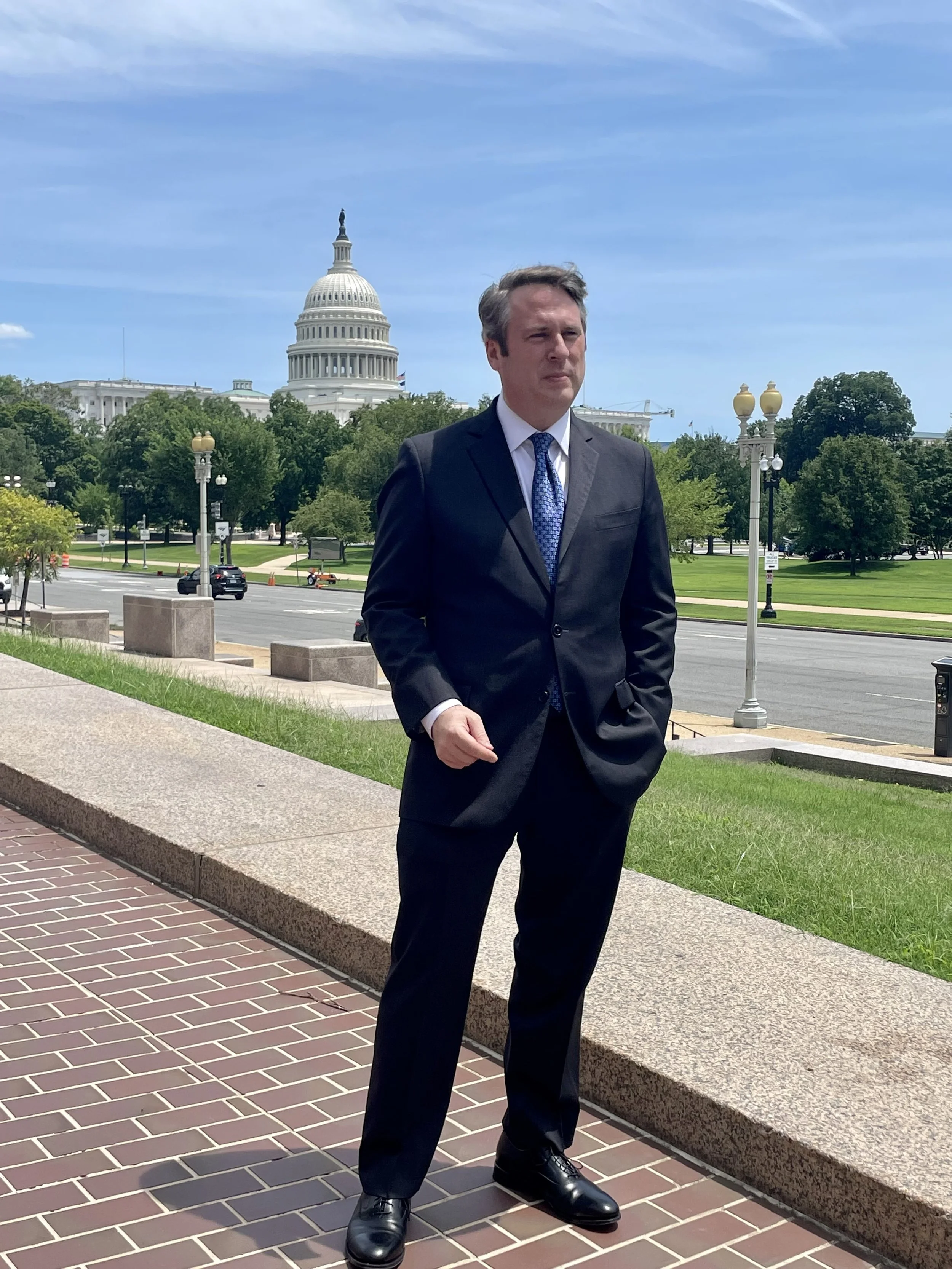 Mike DeCillis standing on street with US Capitol in the background.