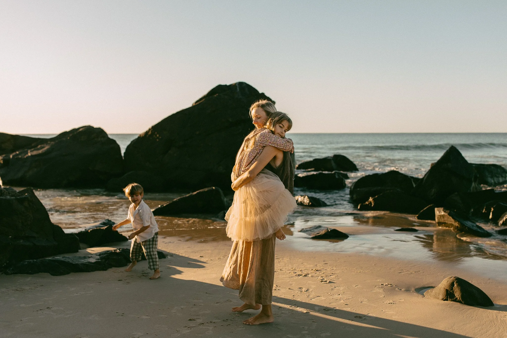 Gold Coast motherhood photographer capturing a mum with her child at Burleigh.