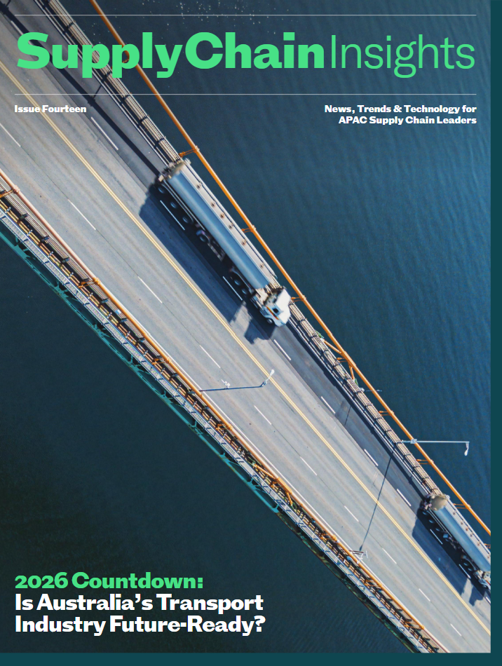 Aerial view of a bridge over water with freight trucks driving across it, shown from above.