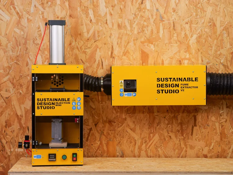 Fume Extractor V2 sat alongside a desktop plastic recycling machine in a workshop