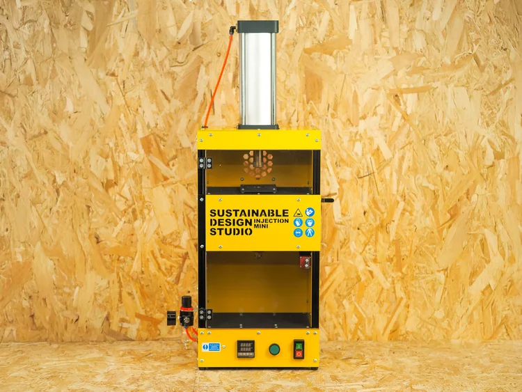 Injection Mini V2 on a workshop desk showing its 25 kg compact footprint