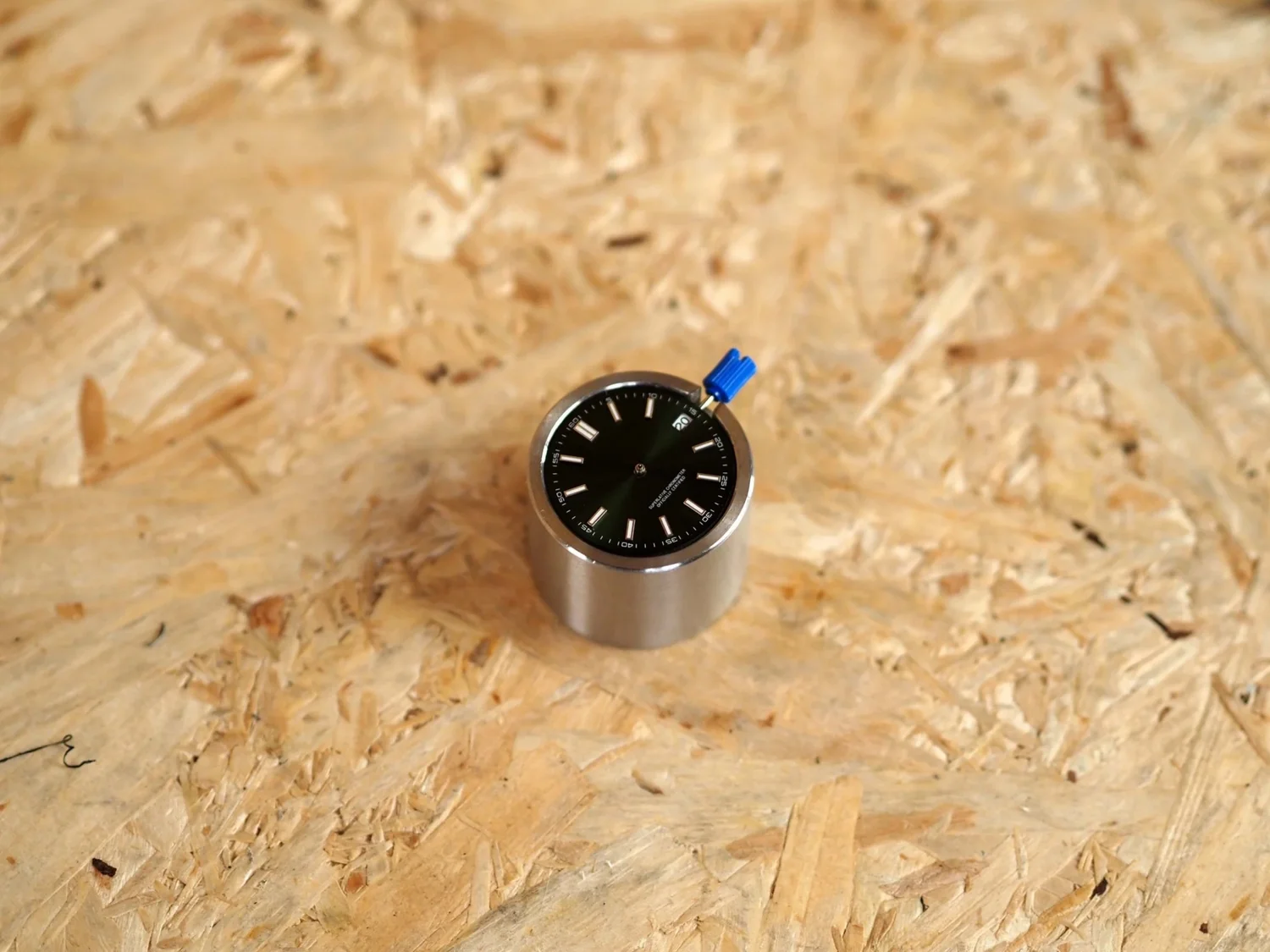 Dial sitting flat against the NH35 movement, both locating pins seated.