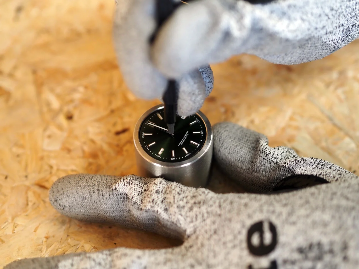 Hour, minute, and second hands pressed onto the NH35 in a movement holder.