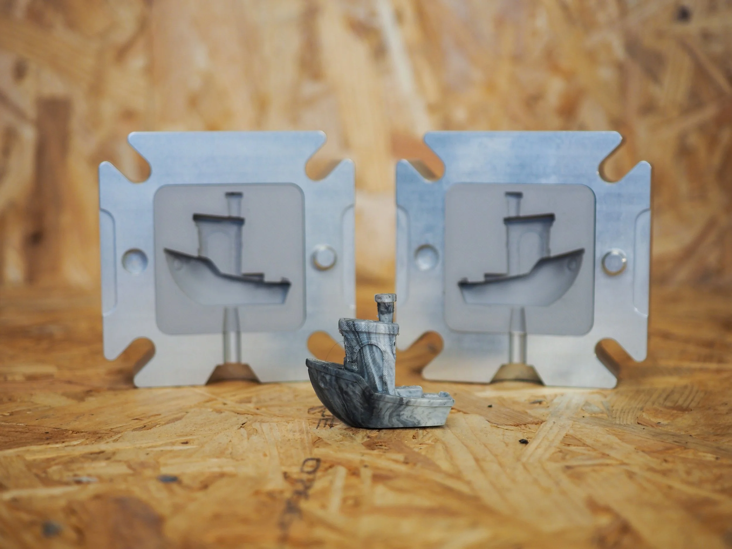 3D Printed Insert Holder Mould photographed alongside an FDM-printed Benchy, the canonical product image for the hybrid 3D printed mould system