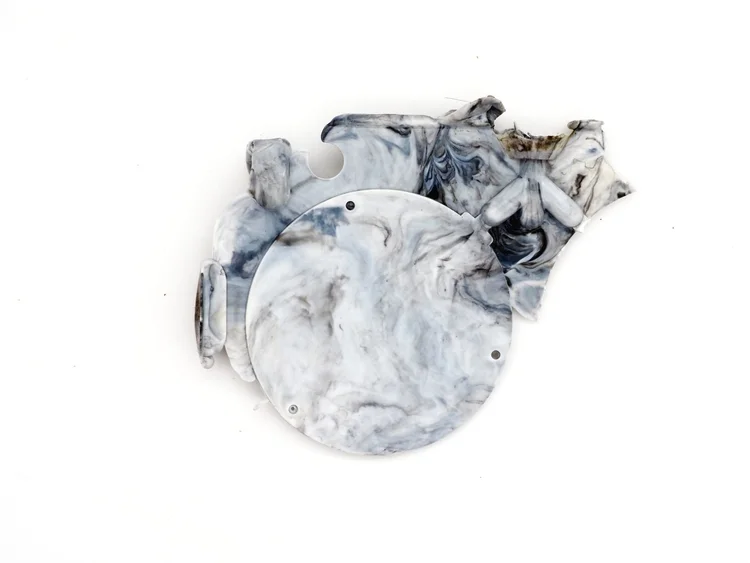 A moulded part with a thin fin of excess plastic running along the seam where the two mould halves met.