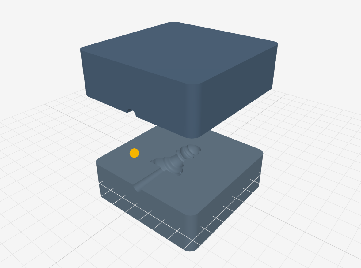 Two 3D printed mould insert halves separated to show the cavity, sprue channel, and orange sprue position marker.