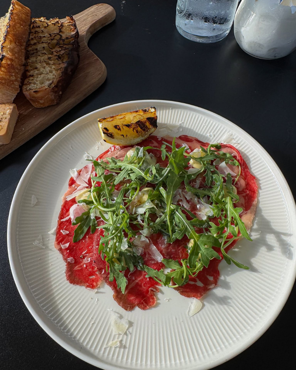 Thinly sliced beef with rocket, cheese and grilled lemon served at Restaurant Fleisch in Copenhagen’s Meatpacking District.