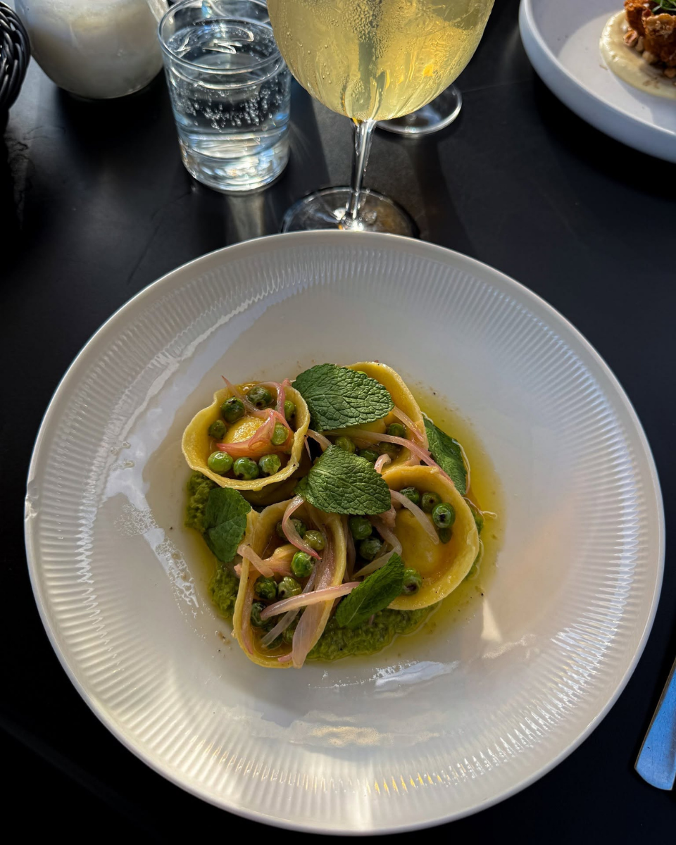 Ravioli served with green peas, herbs and a drink at Restaurant Fleisch in Copenhagen’s Meatpacking District.