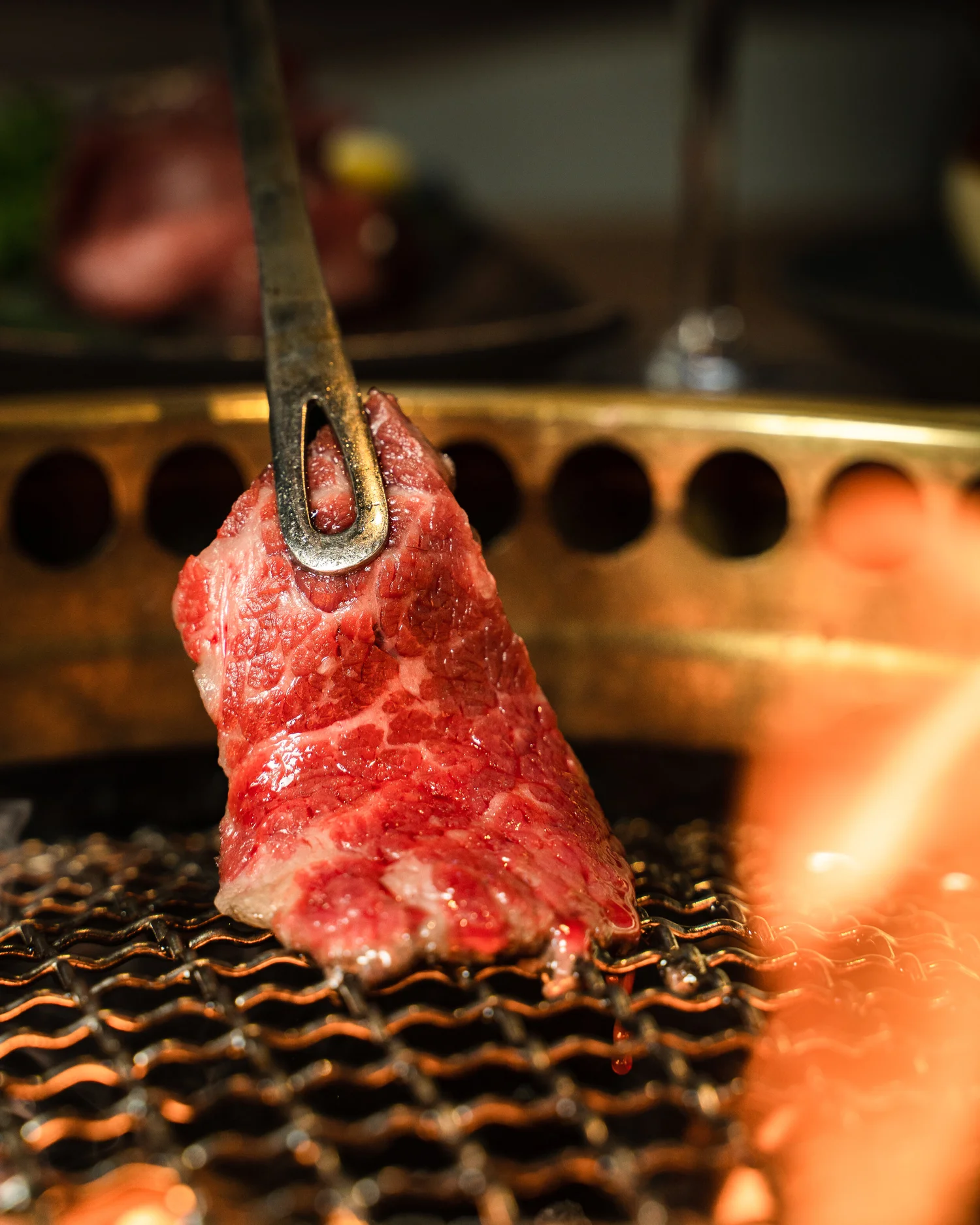 A slice of marbled Wagyu lifted off the grill at Gyu Shige