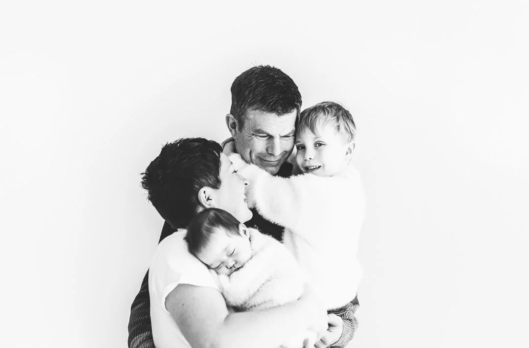 A family of four during their family and newborn photoshoot in Saffron Walden, Essex