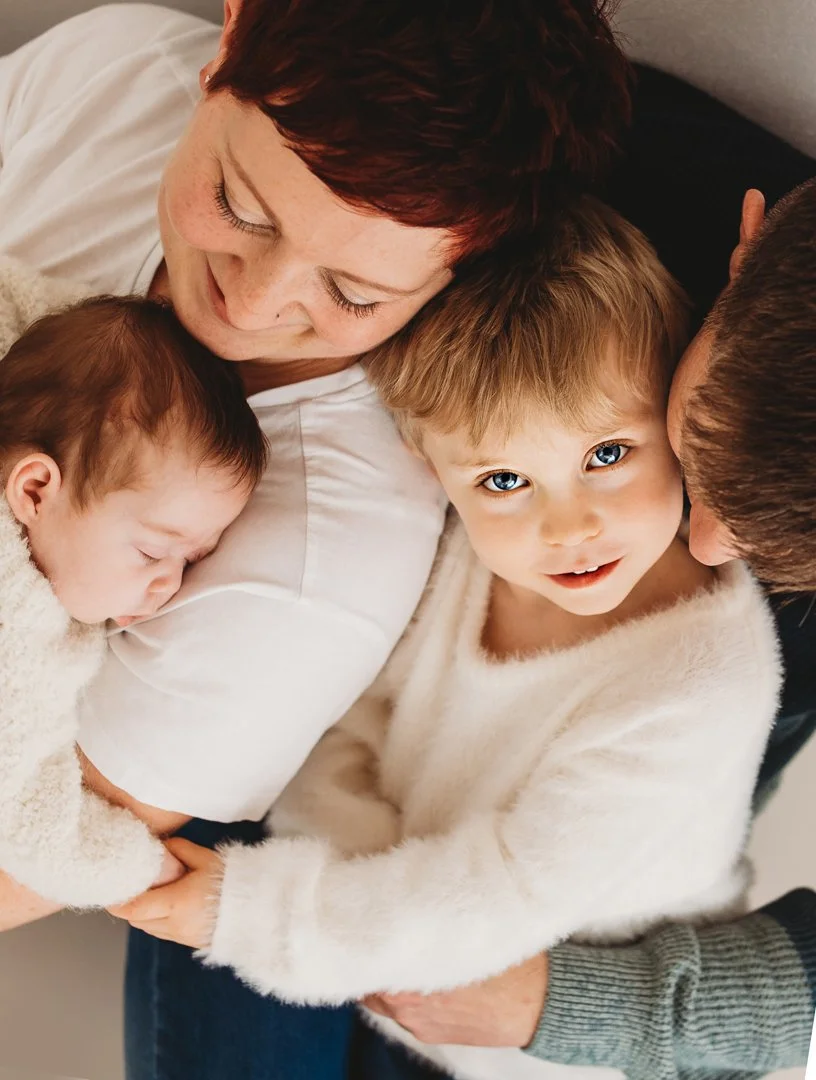 Candid close up of family having cuddles and not looking at the camera during their family  photoshoot in Essex/Cambridge