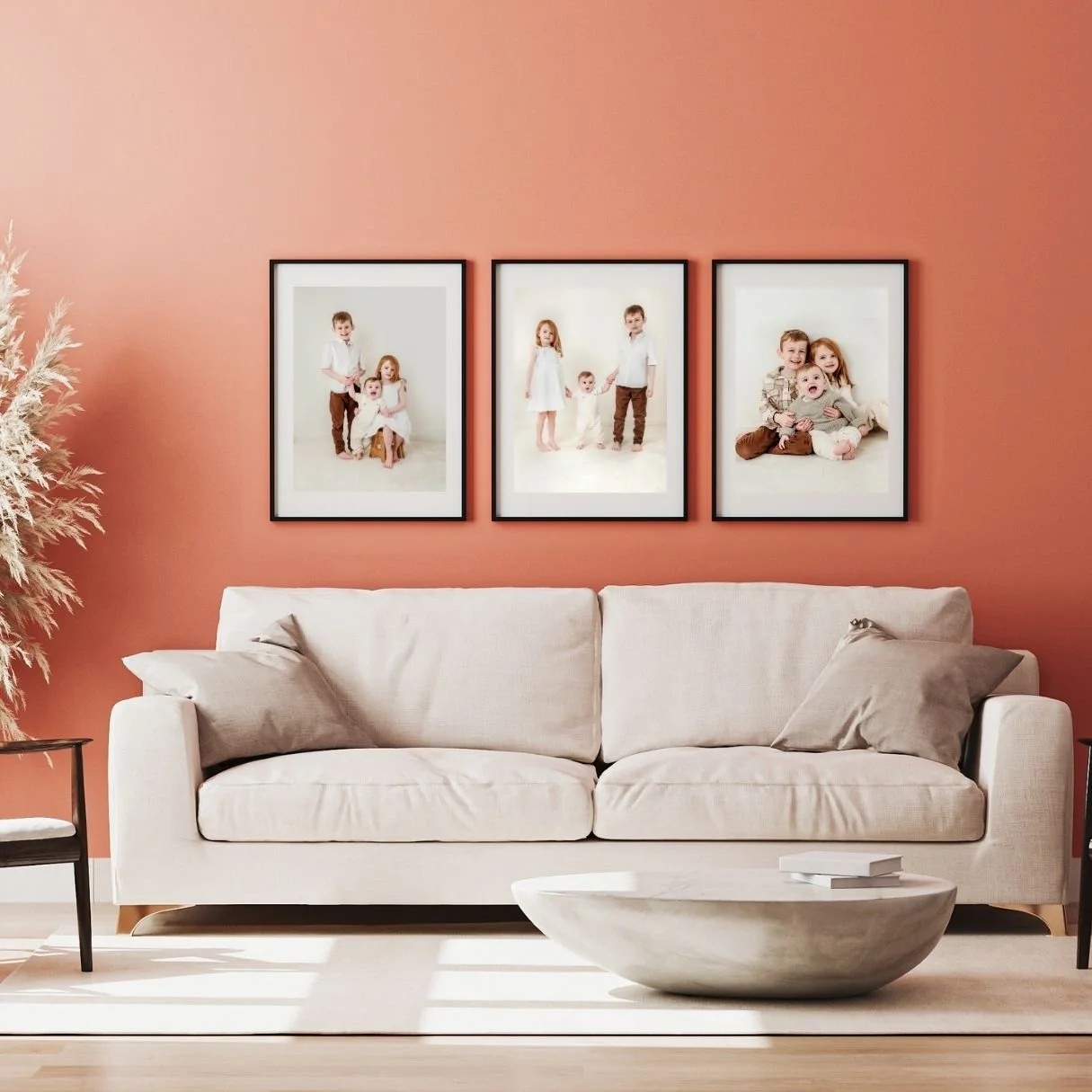 3 large framed prints of a family photoshoot hanging on the wall of a living room.
