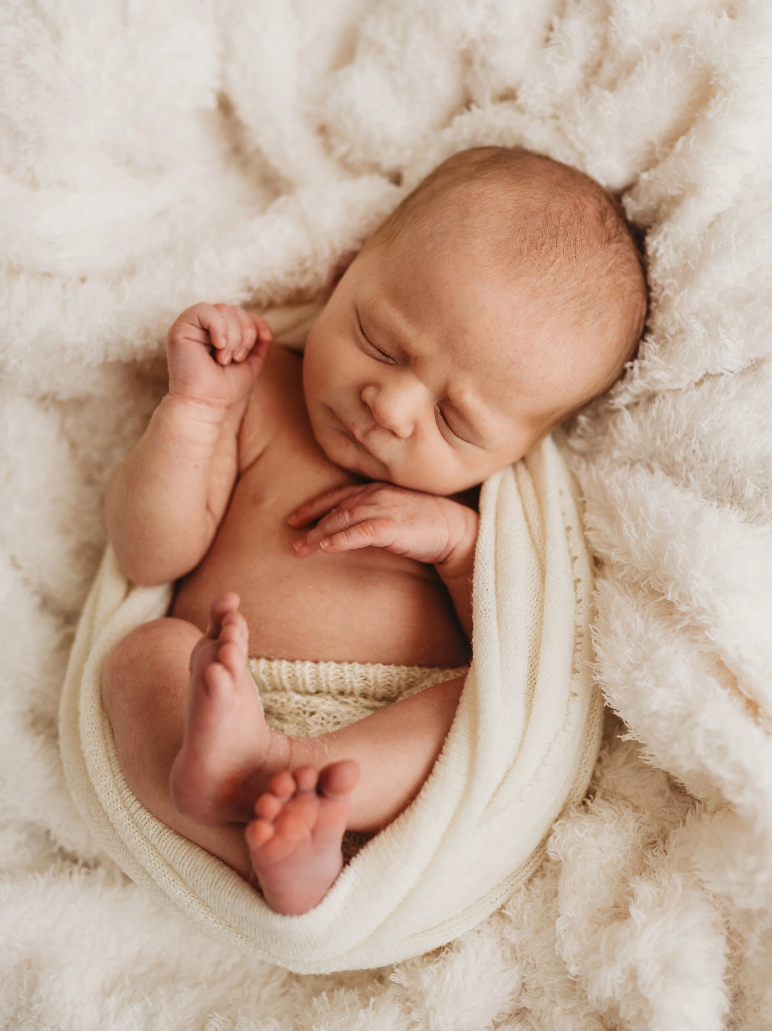 Newborn bundled in blankets and knitted outfit, newborn photoshoot in Saffron Walden Essex. Jodie Wilson Photography