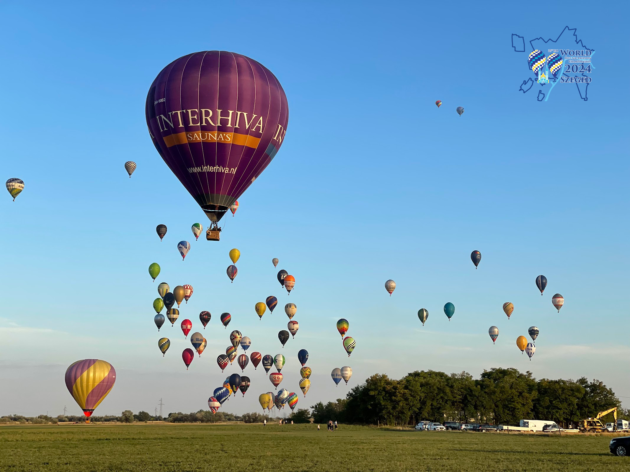Several hot air balloons in the air at a hot air balloon championship