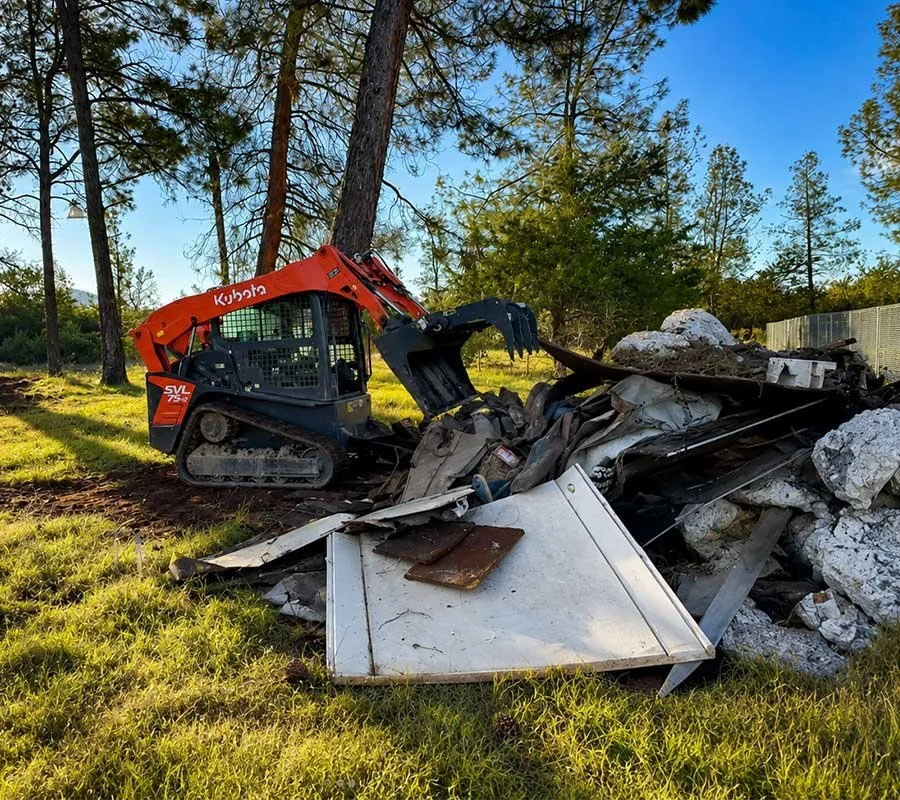 Junk removal team hauling furniture out of a home in Redding, CA