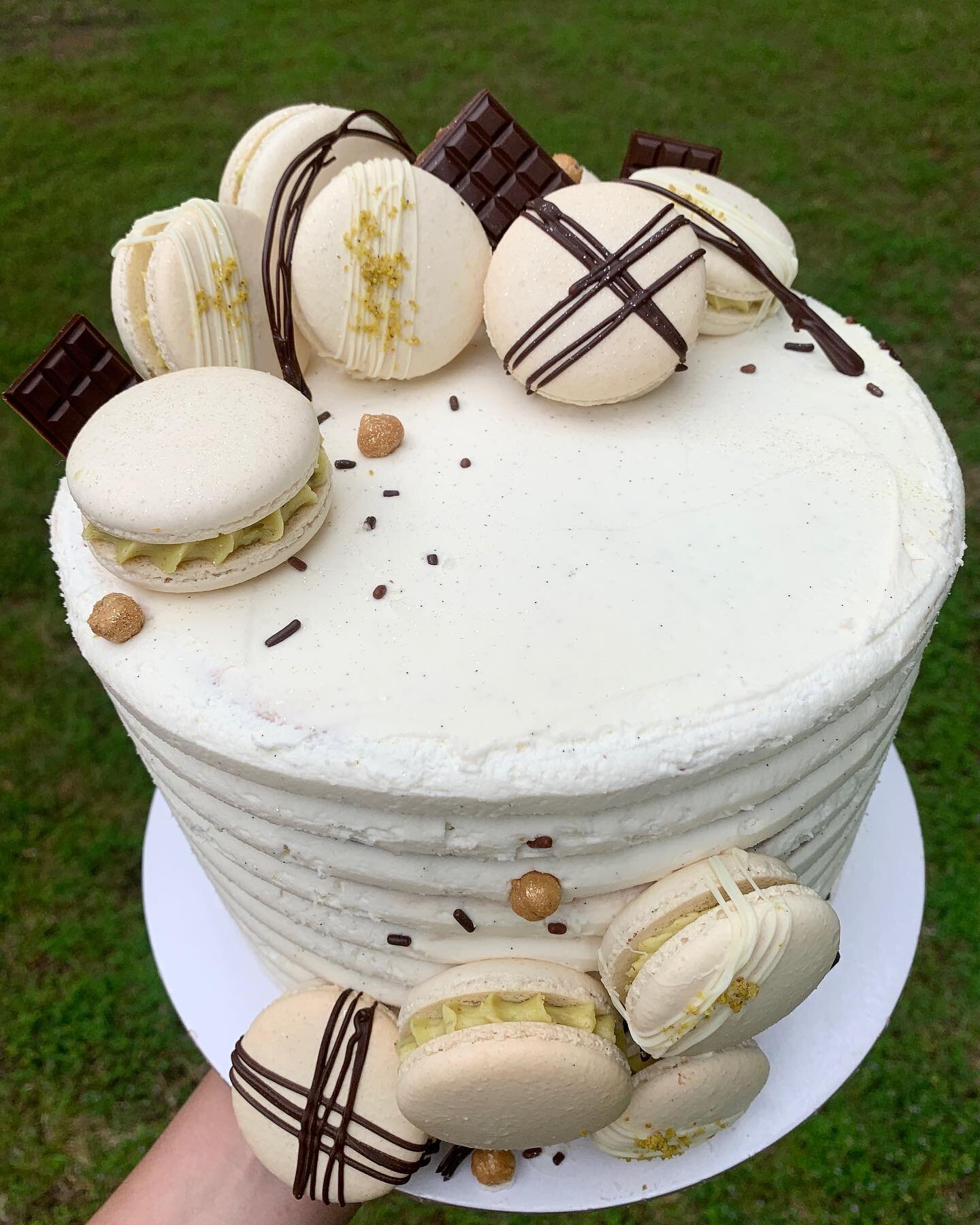 Sweet cake for a sweet little boy. 
Don&rsquo;t let my one hand hold fool you, this cake was large and heavy! 😅

Gluten Free Chocolate Cake with Chocolate and Vanilla Swiss Meringue Buttercream. And macarons of course. 

#fayettevillearkansas #fayet