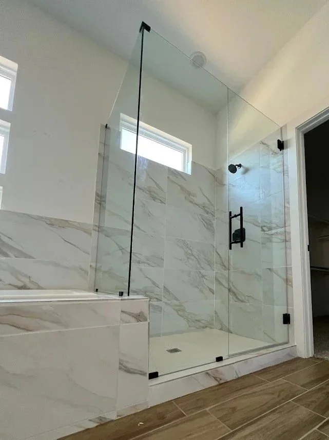 Custom frameless pony wall corner shower glass installation in San Antonio, Texas