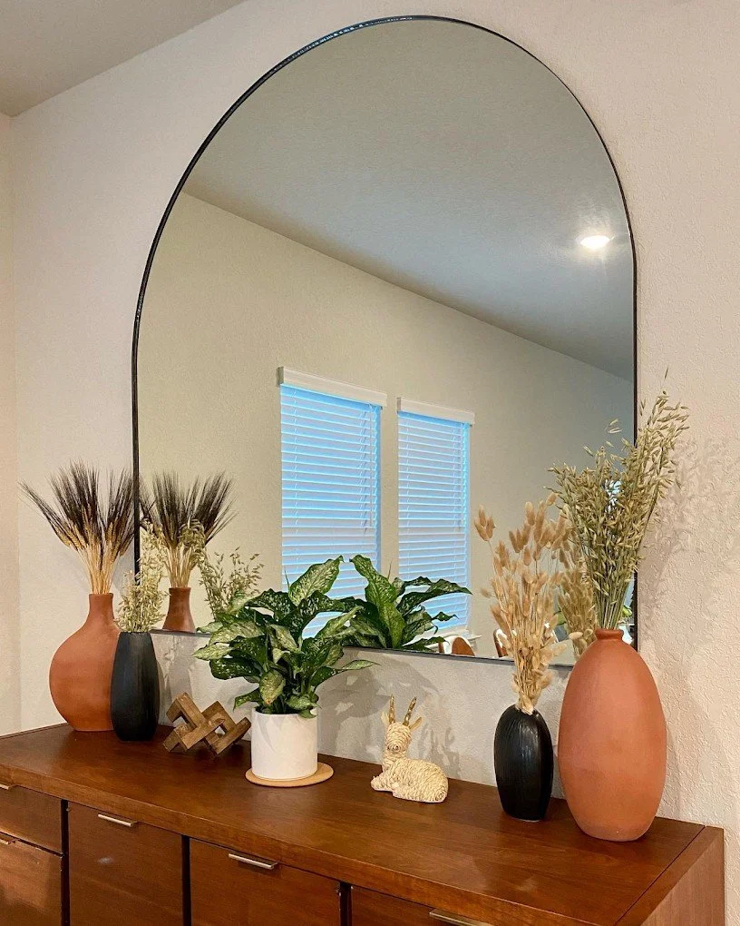Custom arched entry mirror with black metal framing installed in Schertz, Texas