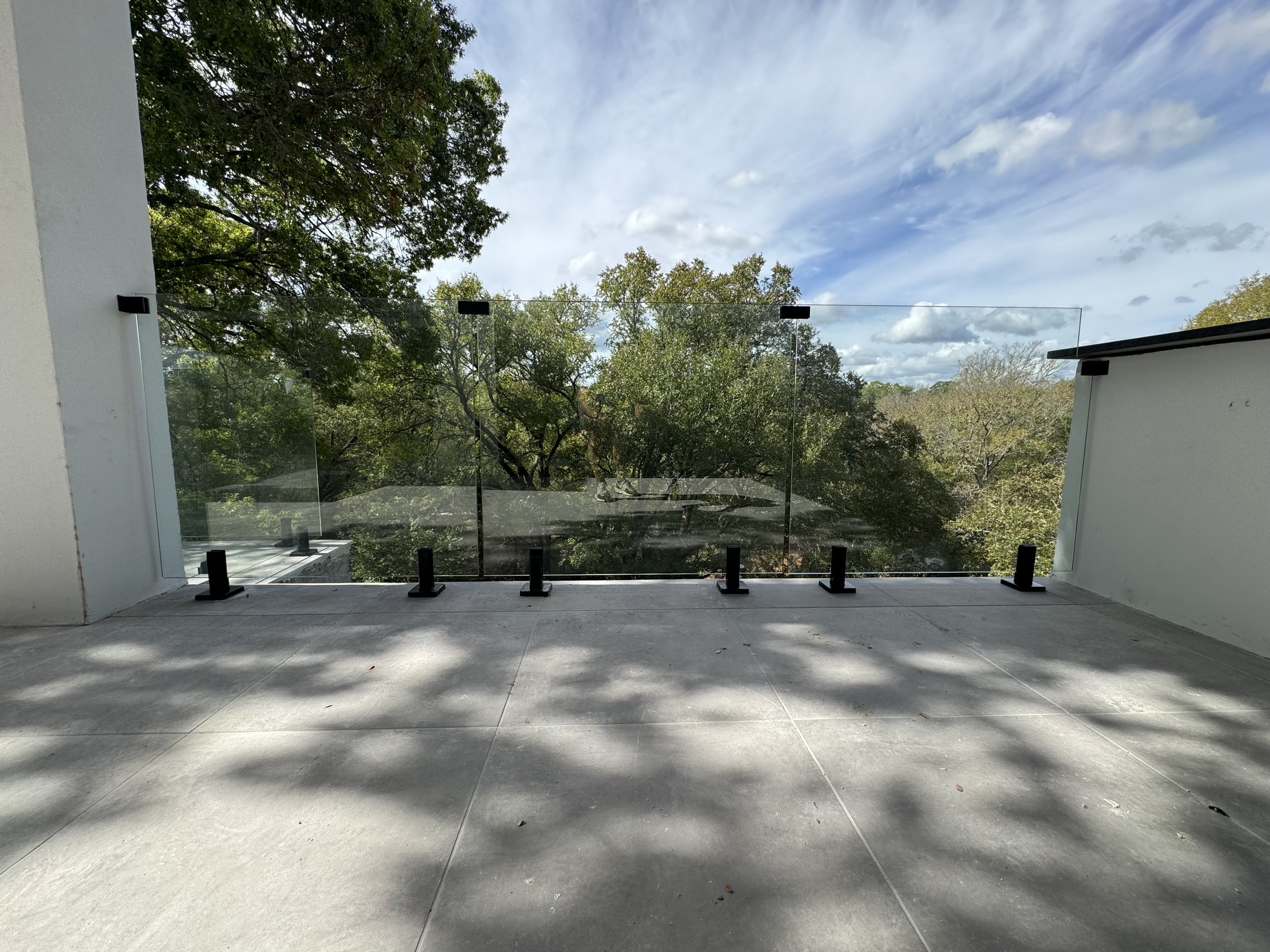 Custom patio kitchen frameless glass handrail install by Proline Glass And Mirror in San Antonio, Texas.