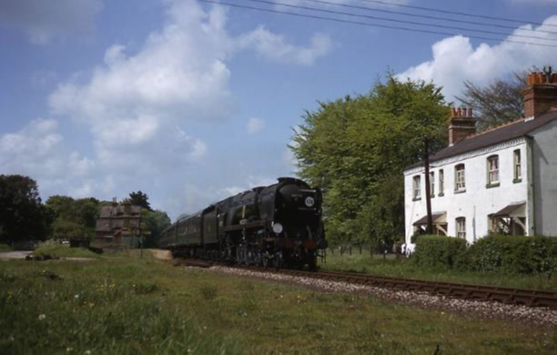 Diverted Bournemouth to Waterloo express passing Itchen Abbas in 1966 hauled by Battle of Britain class Sir Archibald Sinclair. (The white railway cottages still stand) 