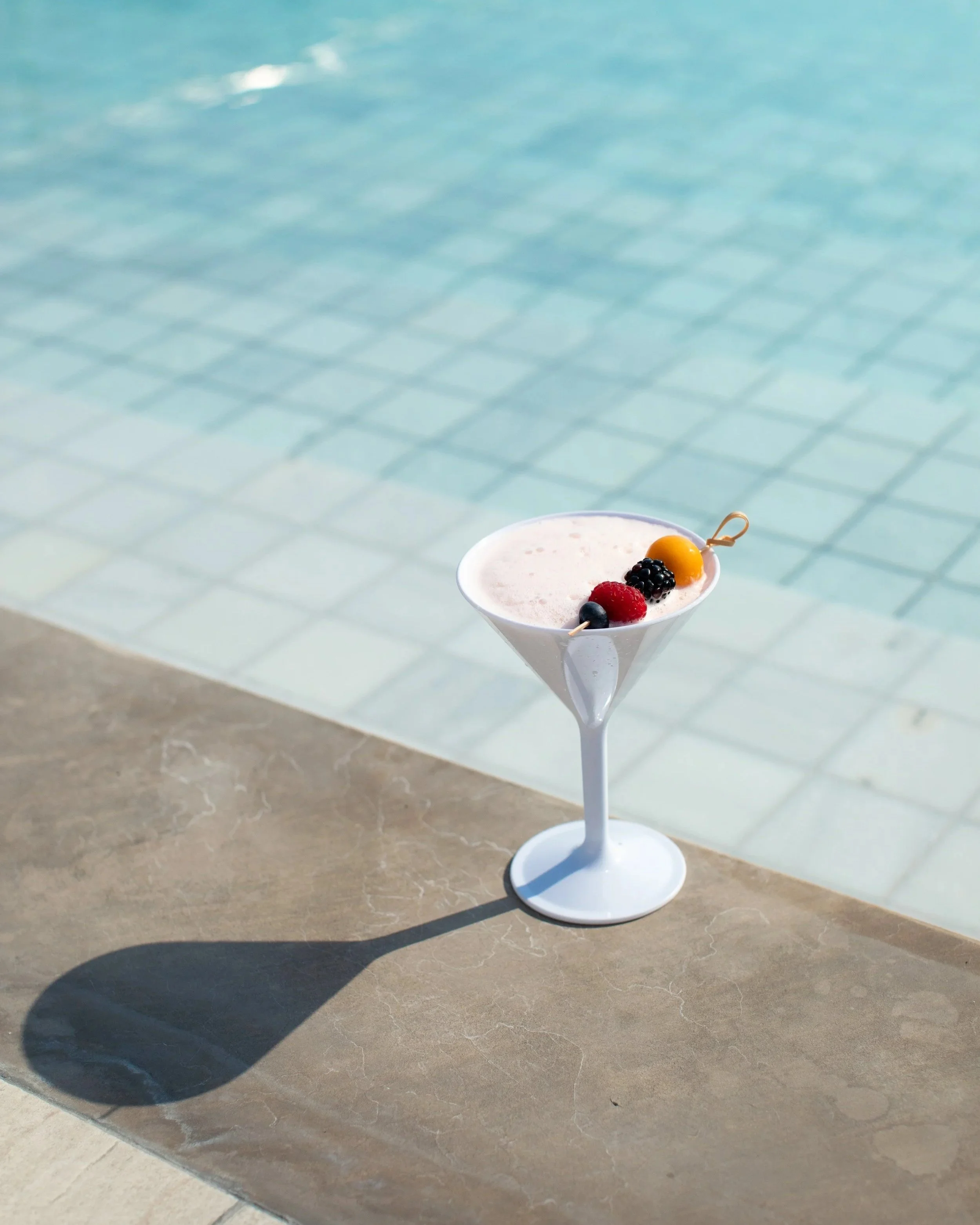 cocktail glass by pool for luxury hotel photo shoot