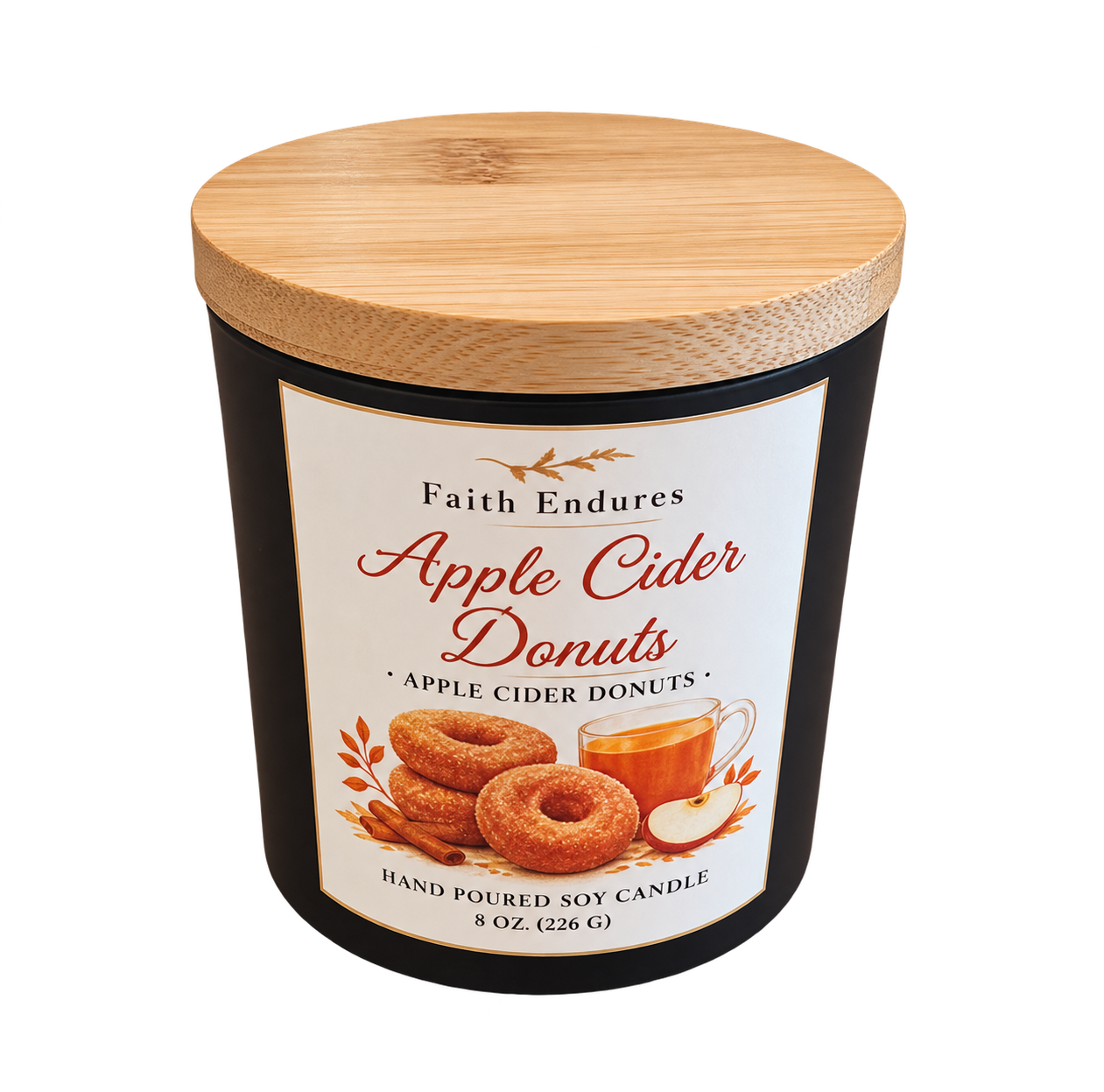 A black candle container with a wooden lid, labeled 'Faith Endures Apple Cider Donuts,' featuring images of apple cider, apple slices, and apple cider donuts.