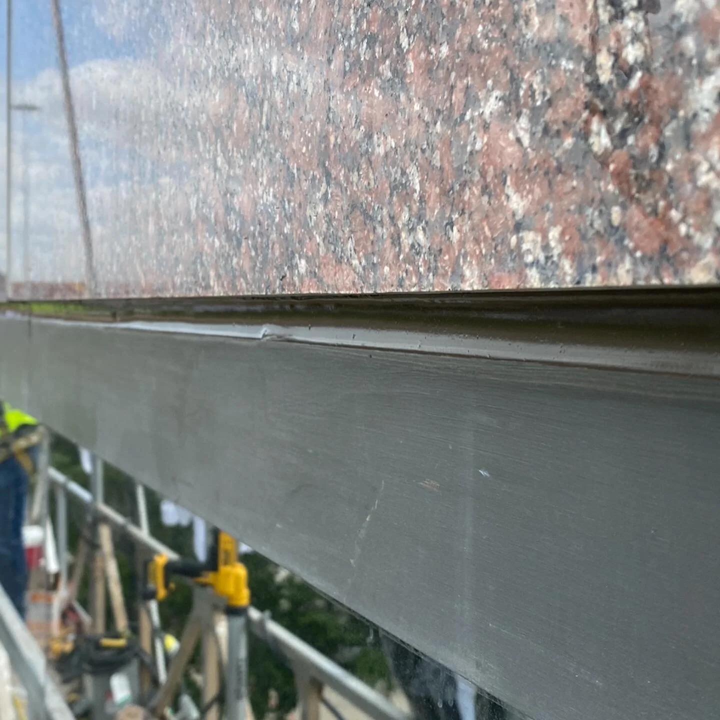 M&amp;M Caulking at it in the early morning .Safety first PPE and full body harness equipment.