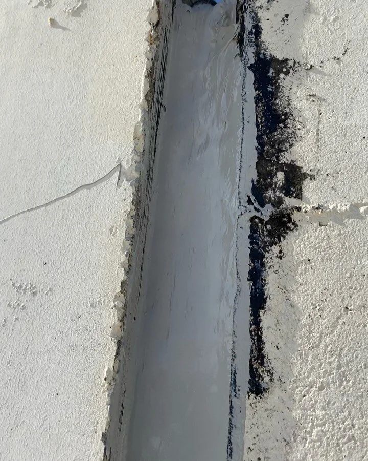 Roof top parapet wall expansion joints . Cut out prepp and reseal . Master Seal NP2 buckets color stone