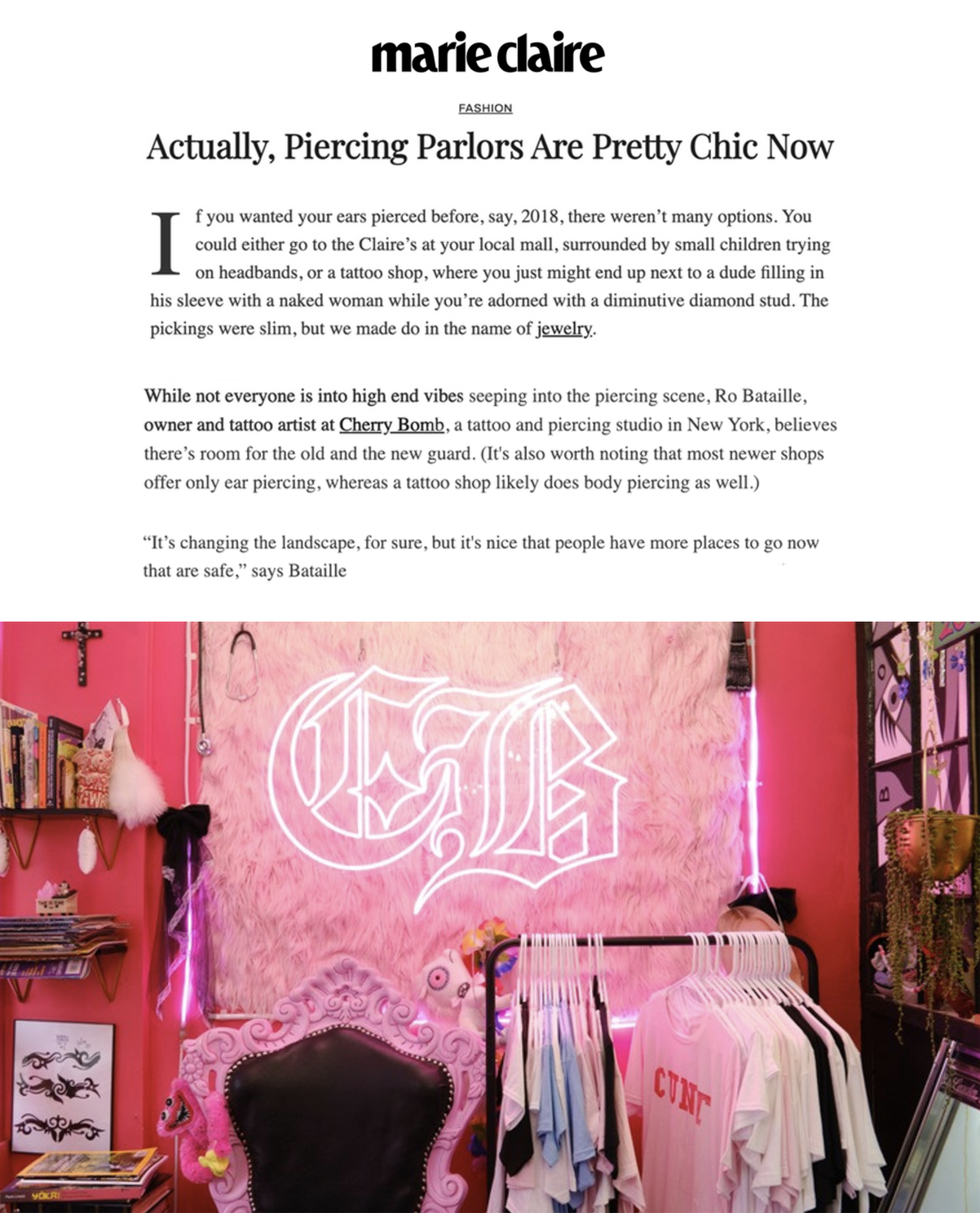 Interior of a pink-themed tattoo studio with neon sign of a monogram, clothing rack with T-shirts, pink furry wall decor, and shelves with books and artwork.