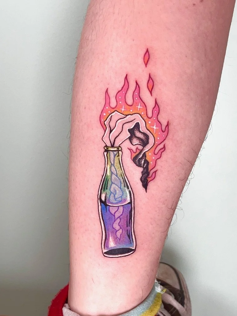 Tattoo of a traditional glass bottle with rainbow-colored liquid and pink flames emerging from the top.