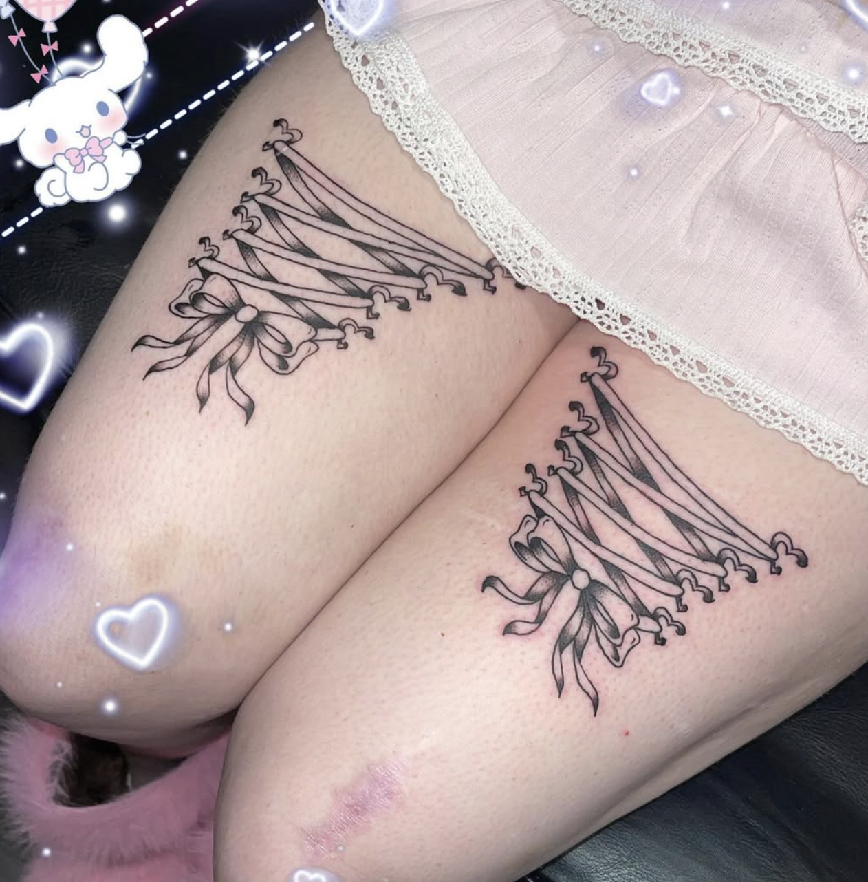 Tattoo of a crown with ribbons on the upper thigh of a person.