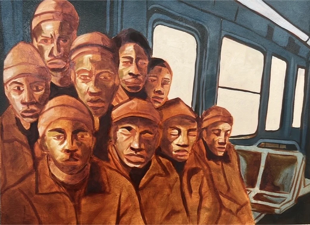 A group of men in prison uniforms sitting and standing inside a bus, with windows and seats visible in the background.