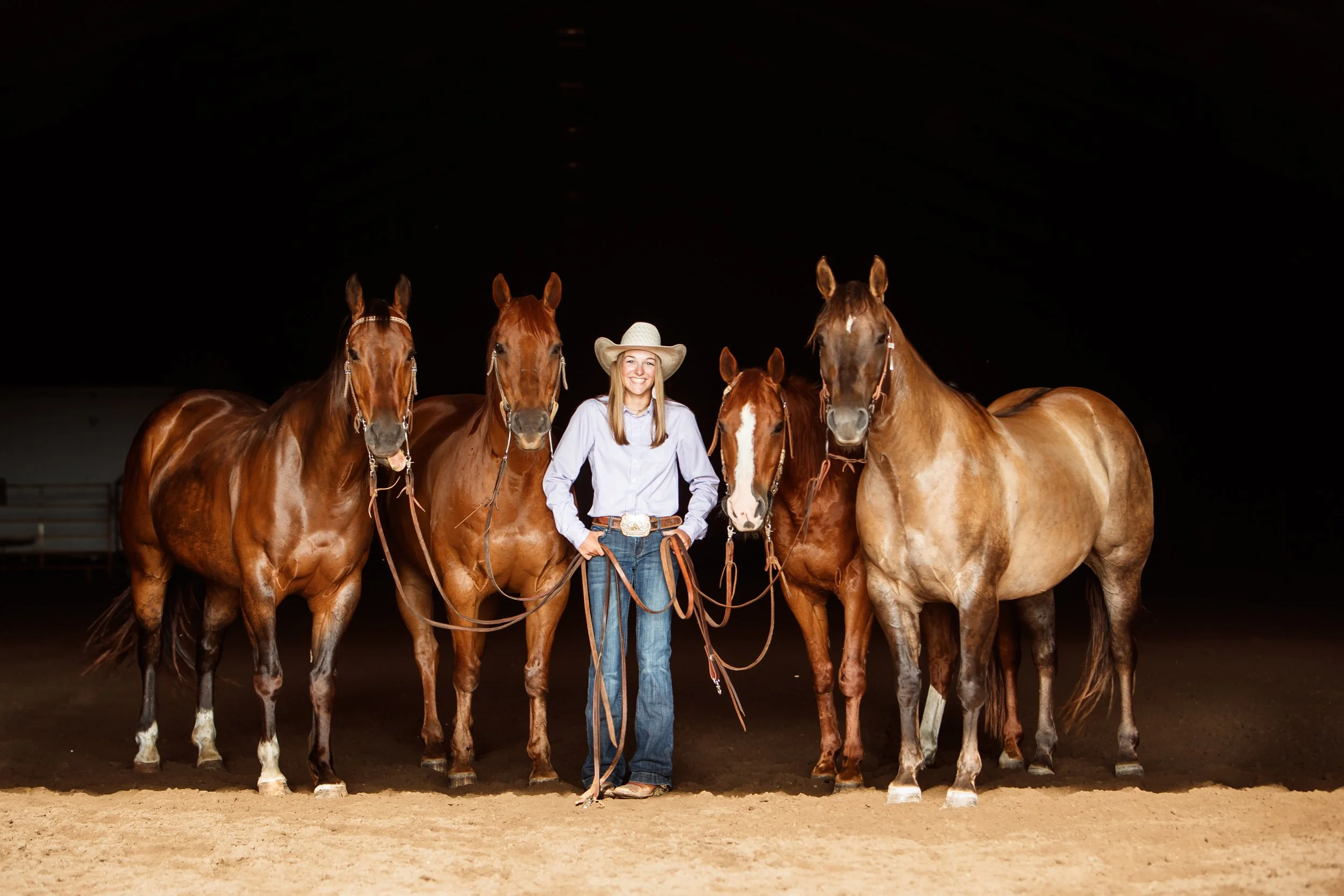 Central Nebraska high school senior with her four horses with a black background