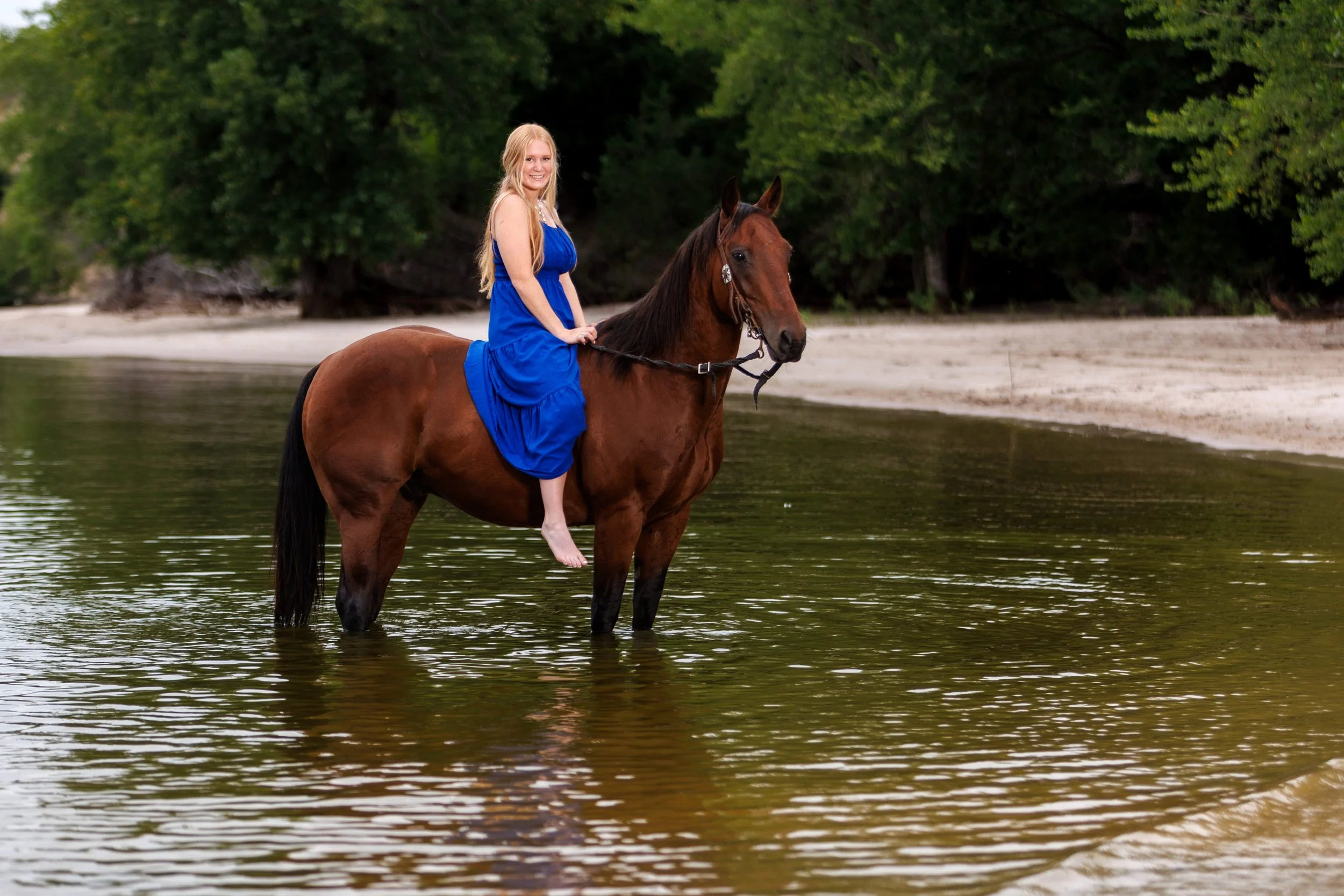 nebraska senior equine photographer haylea on horse at lake.jpg