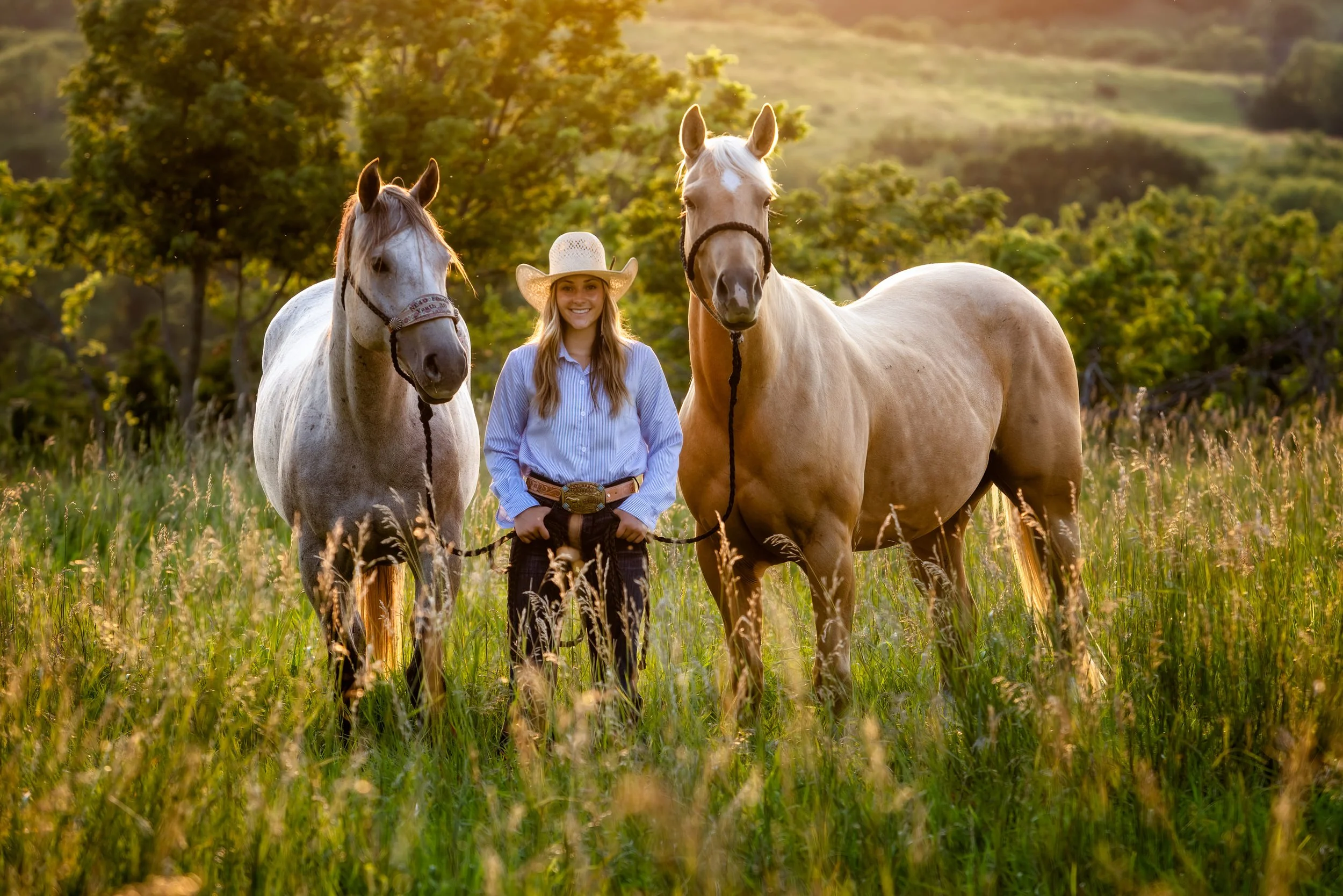 High school senior Alex at sunset with her 2 horses a buckskin and palomino