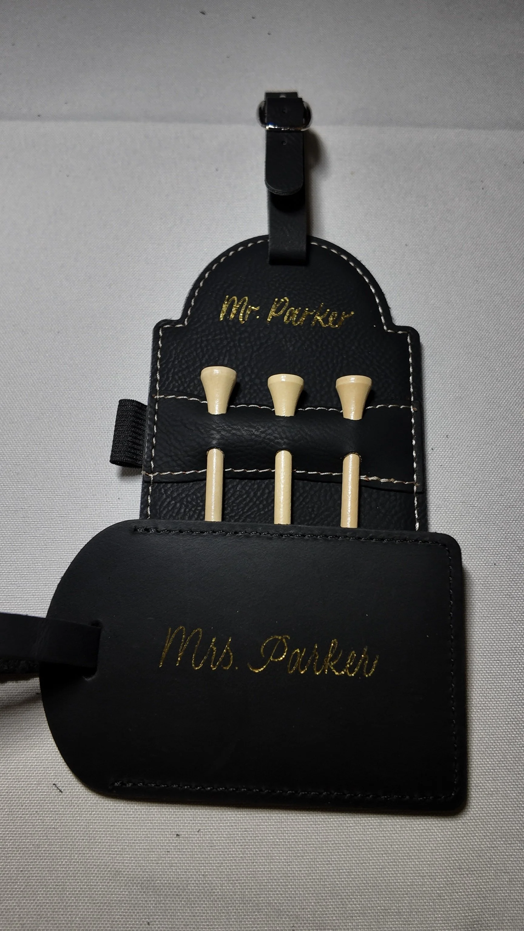 Matching set Golf Tee Tag engraved in gold and a leather luggage tag heat foiled in gold calligraphy