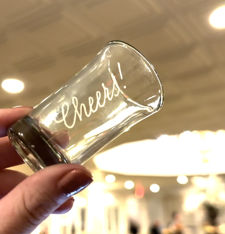 Glass shot glass engraved with "cheers!"