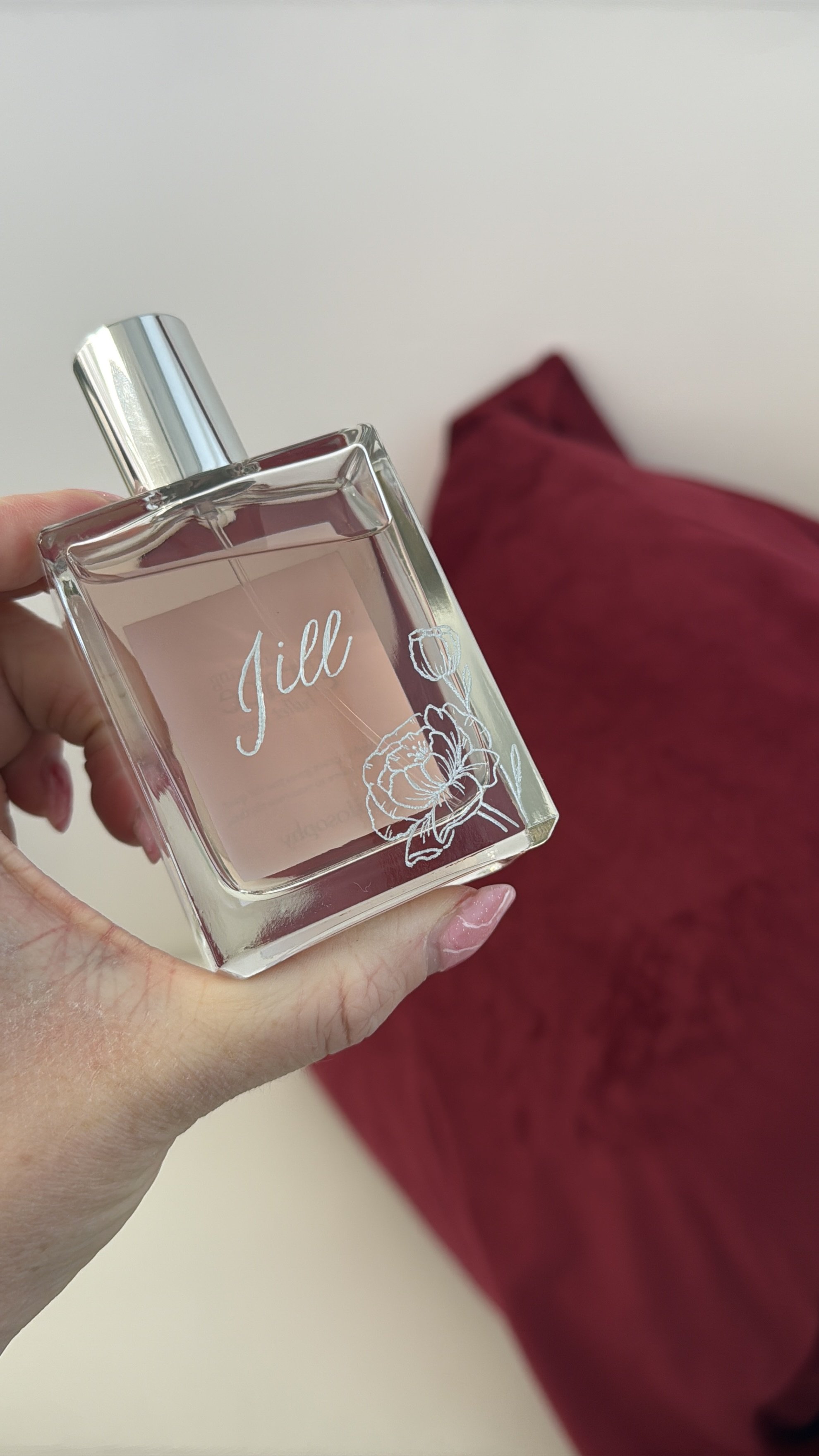 Glass perfume bottle engraved with the name Jill and floral in bottom right corner