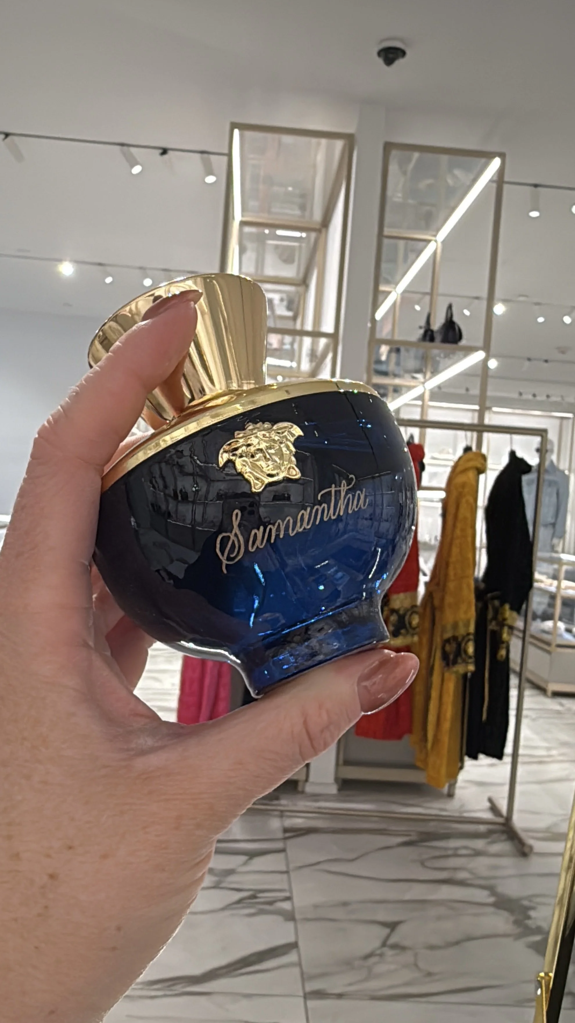 Blue perfume bottle engraved with the name Samantha in gold calligraphy