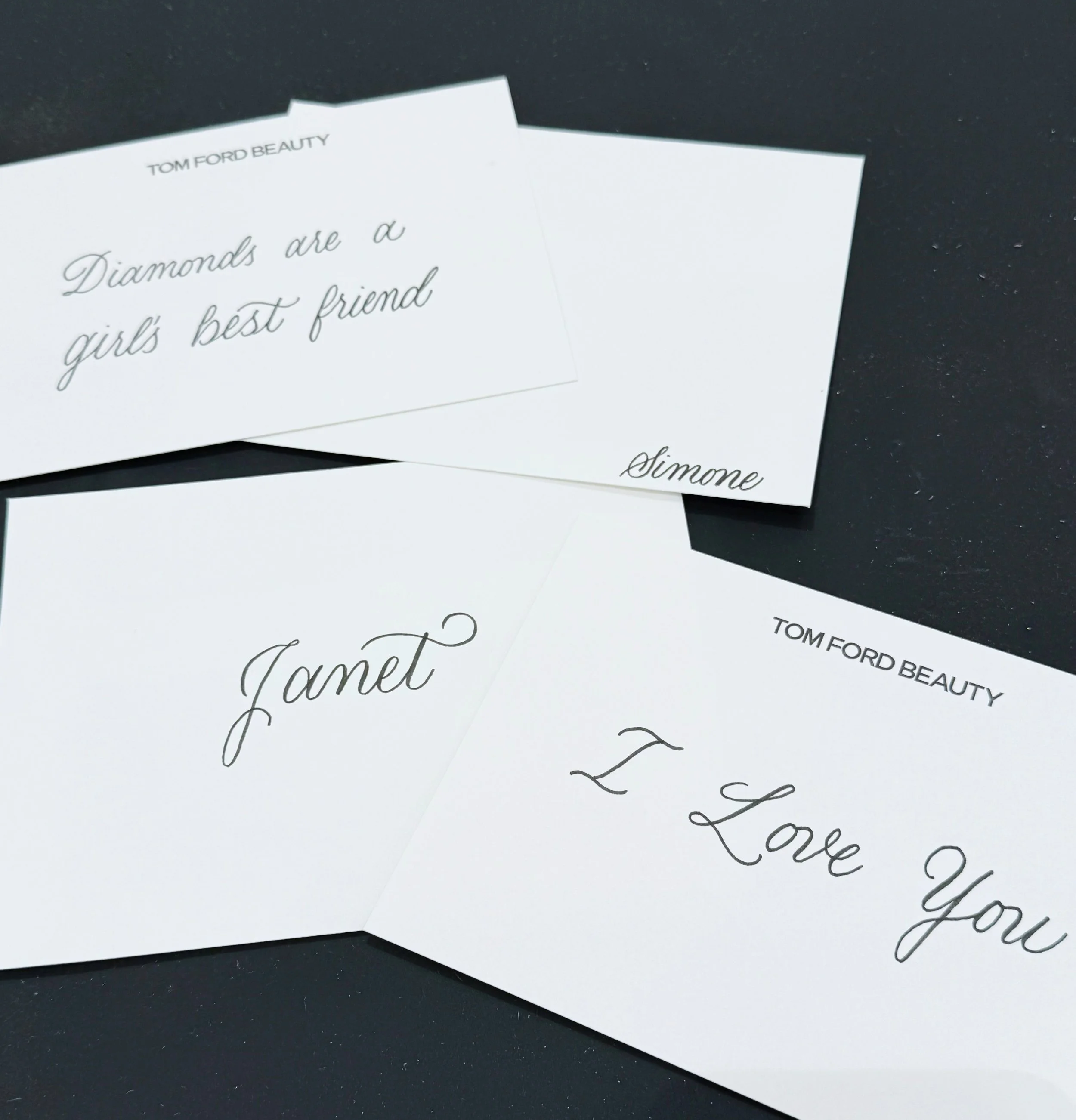 White note cards with black ink in calligraphy