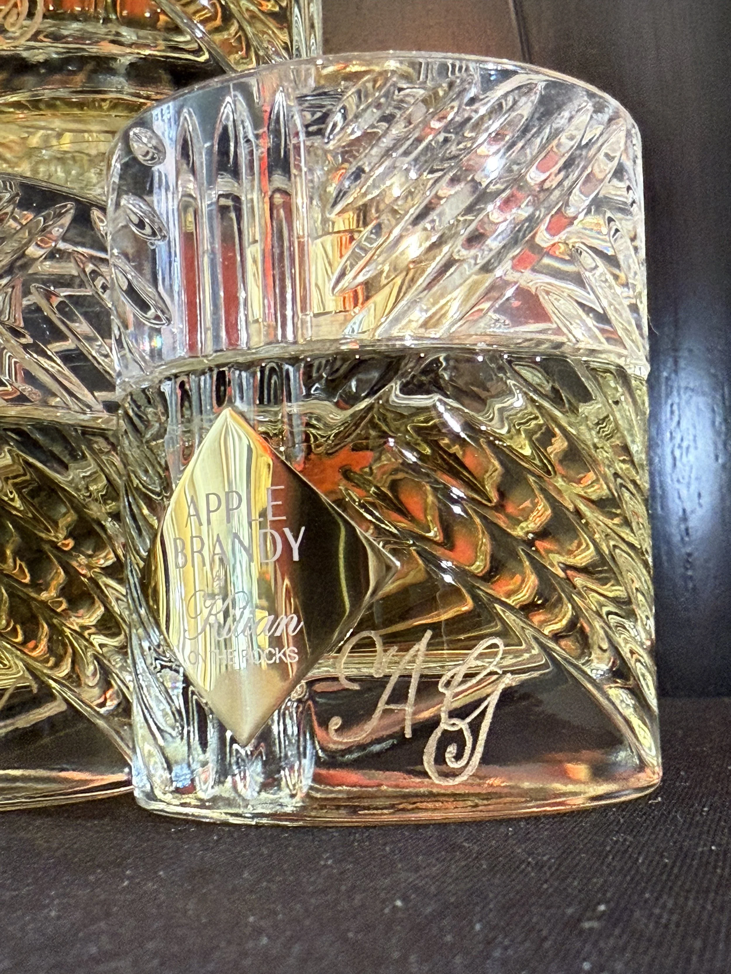 Engraved perfume bottle with gold initials in calligraphy script "AG"