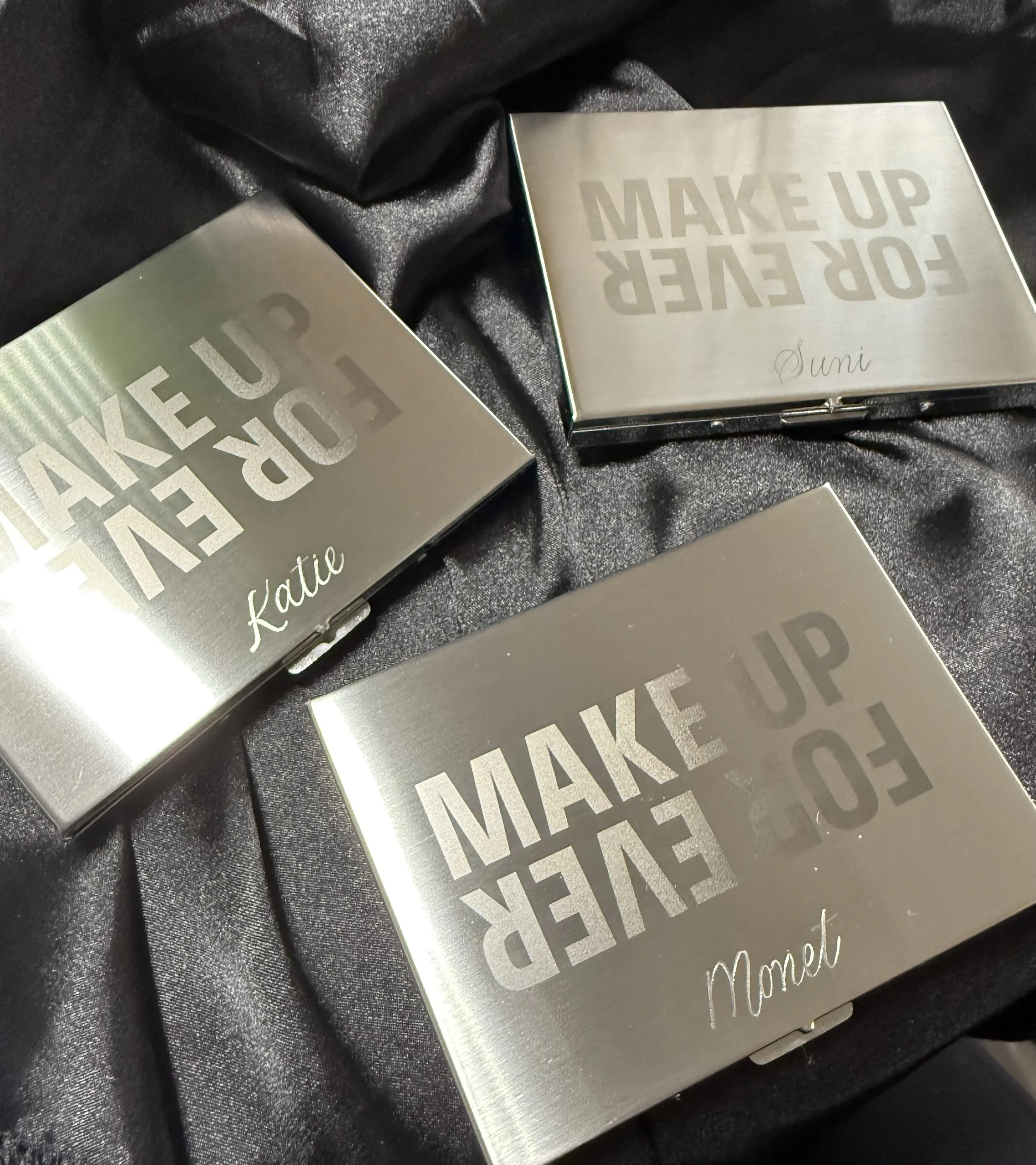 Silver metal case engraved with Make Up For Ever logo for brand event. Hand calligraphy to add in name personalization